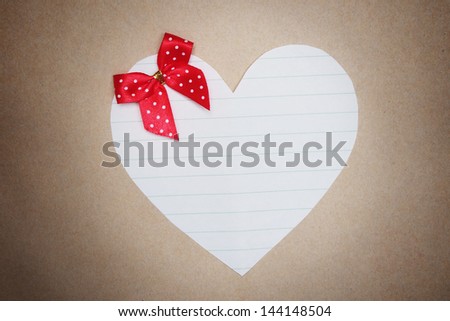 white heart shape paper with line on brown background