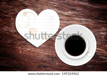 coffee cup and paper (heart shape) with stain on wood