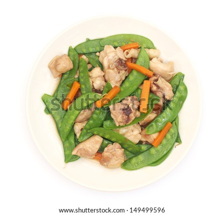 Stir fried snow peas with chicken on plate - with clipping path