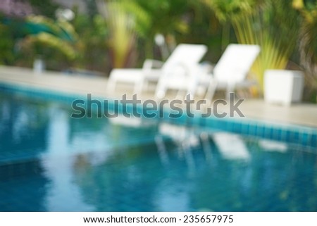 blurred swimming pool and white pool bed  useful for background