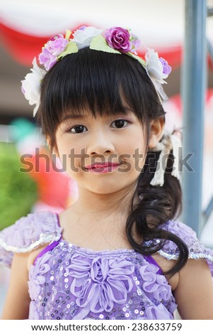 portrait of adorable asian  little  girl in purple fairy fancy dress, five years old