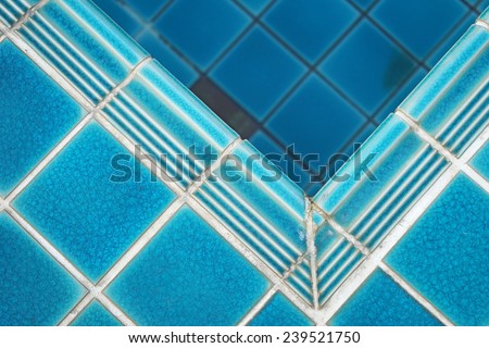 ceramic  floor beside the blue swimming pool, top view