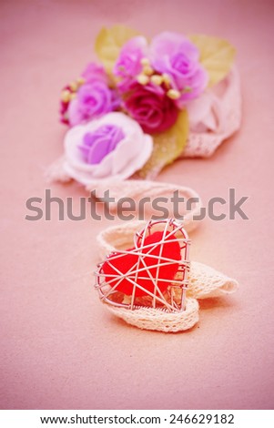 heart in wire mesh and lace on grunge paper with pink vintage color, valentine background