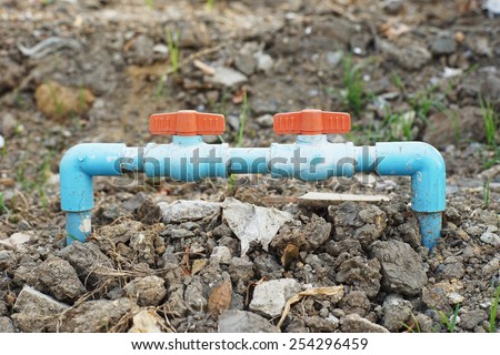 couple red dirty plastic valves of water tube