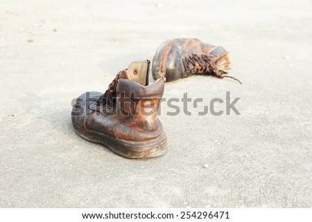 old leather safety shoes on concrete floor