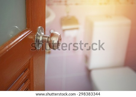 knob with opened door and blur toilet