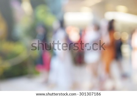 blurred group of women walking in shopping mall