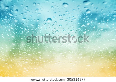blurred rain drops on glass with fog on abstract gradient background