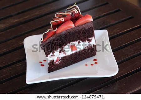 Strawberry Chocolate lover Cake/ A chocolate cake with strawberries with slice on the white plate