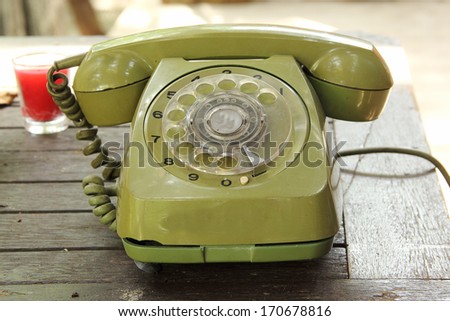 Old green vintage telephone on the table