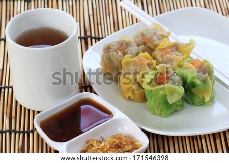 Chinese Streamed Dumpling in the plate and cup of Tea