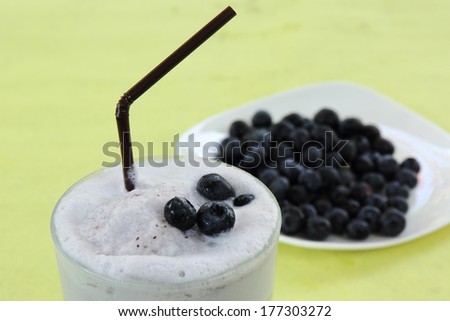 Blueberry milk shake and fruit on the table
