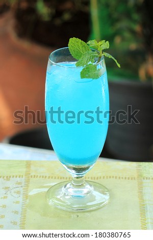 blue hawaiian cocktail on a garden background