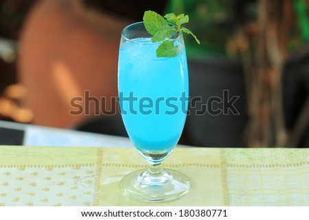 blue hawaiian cocktail on a garden background