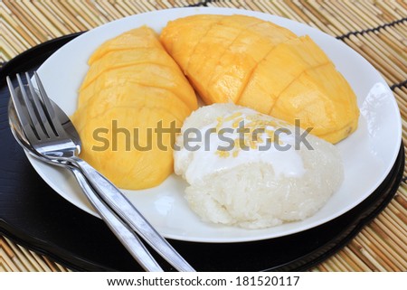 Ripe mango and sticky rice cooked with coconut milk ,Thai dessert
