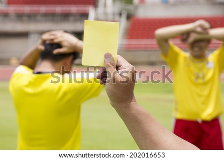 soccer referee show yellow card recorded player foul in the game