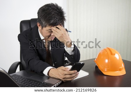 Businessman feeling stressed at work/Asian businessman working with on the desk