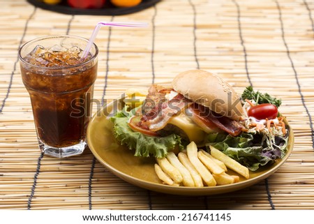 hamburger beef bacon egg french fries and salad with Cola drink