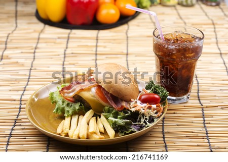 hamburger beef bacon egg french fries and salad with Cola drink