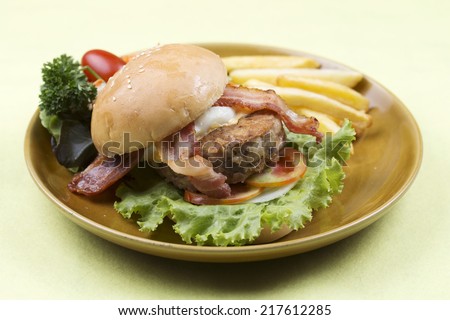 hamburger beef bacon egg french fries and salad