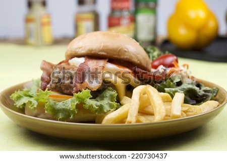 hamburger beef bacon egg french fries and salad