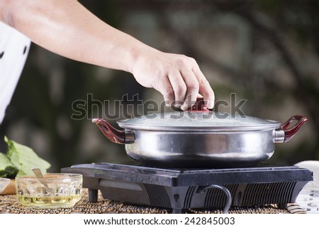 Chef opening the lid of pot before cooking noodle / Cooking Noodle concept