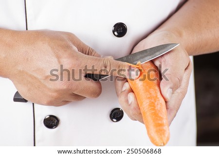 Chef is peeling carrots / cooking Japanese pork curry paste concept