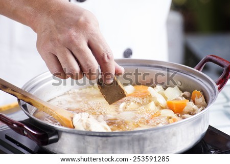 Chef putting Japanese curry paste for cooking / cooking Japanese pork curry paste concept