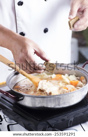 Chef putting Japanese curry paste for cooking / cooking Japanese pork curry paste concept