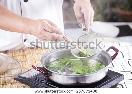 Chef scald vegetable in pot before cooking noodle / Cooking Noodle concept