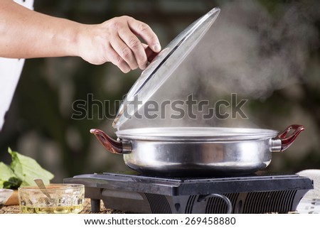 Chef opening the lid of pot before cooking noodle / Cooking Noodle concept