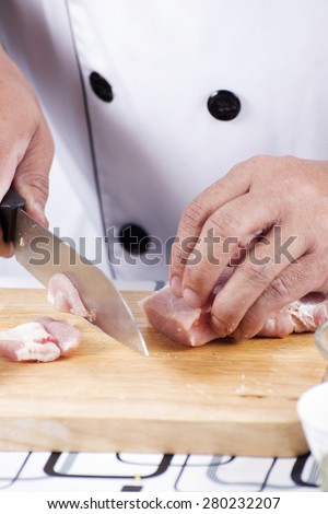 Chef cutting raw pork on wooden board / Cooking Japanese pork curry concept