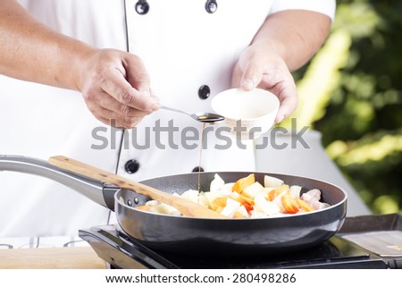 Chef putting seasoning sauce to the pan for cooking Japanese pork curry / cooking Japanese pork curry paste concept