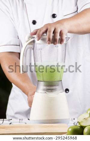 Chef making Green Apple smoothie with blender
