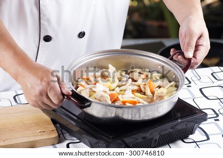 Chef cooking Japanese pork curry on the pan / cooking Japanese pork curry paste concept