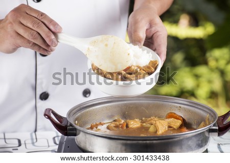 Chef shovel Japanese pork curry with steam rice / cooking Japanese pork curry paste concept