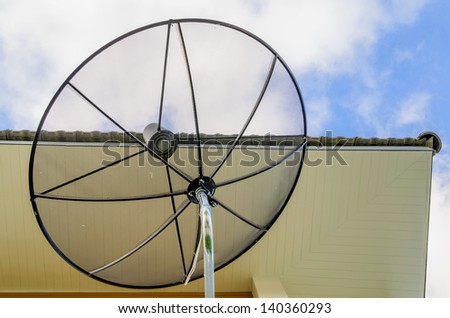 Satellite disc under the house\'s roof
