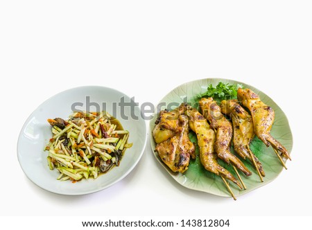 papaya and crab spicy salad with blurred out grill chicken isolated on white