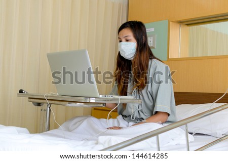 Lady patient working with laptop during in hospital