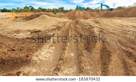 Wheel loader Excavator with backhoe loading sand at eathmoving works in construction site