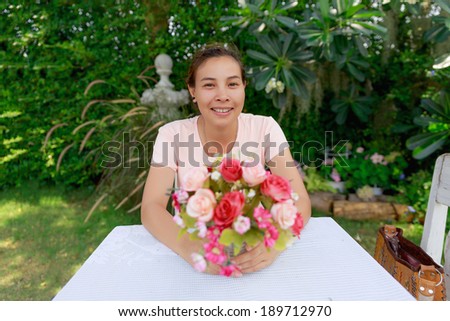 Closeup photograph of a woman showing a bunch of assorted flowers