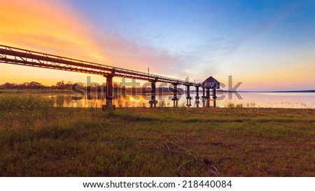 water pump station in Ang Dok Krai pond with sunset behind, Rayong, East of Thailand