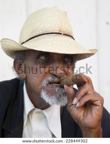 TRINIDAD, CUBA - CIRCA  DECEMBER 2013: Unidentified Cuban man smoking cigar