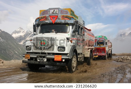 LADAKH, INDIA - CIRCA AUGUST 2011:  Decorated Indian fuel tankers climb above the Himalayan clouds as they negotiate the hazardous Rohtang Pass