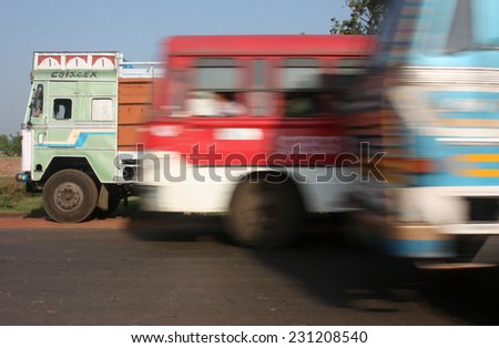 WEST BENGAL, INDIA - CIRCA 2012: Triple overtaking on busy Bengali highway