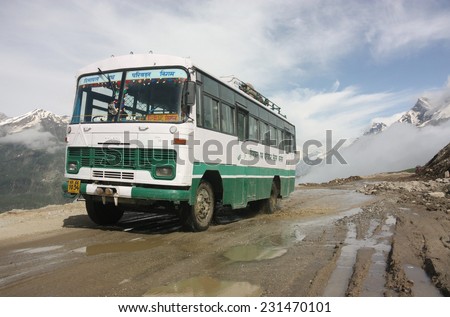 LADAKH, INDIA - CIRCA AUGUST 2011: Indian bus climbs above the Himalayan clouds as it negotiates the hazardous Rohtang Pass