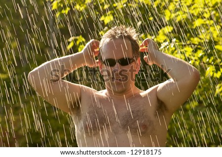 Man caught in the rain while the sun is still there