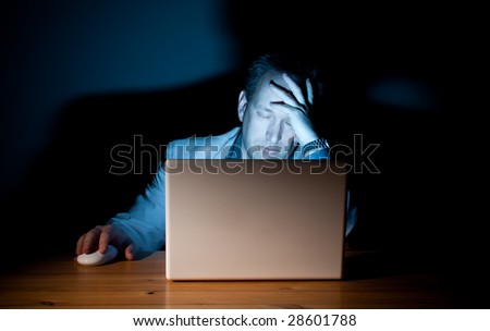 Man asleep in front of his computer
