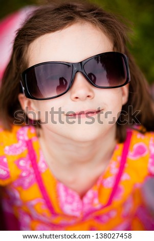 Little girl with sunglasses smiling