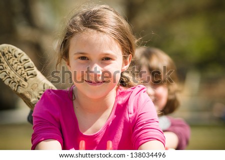 Girl smiling while her brother is messing around
